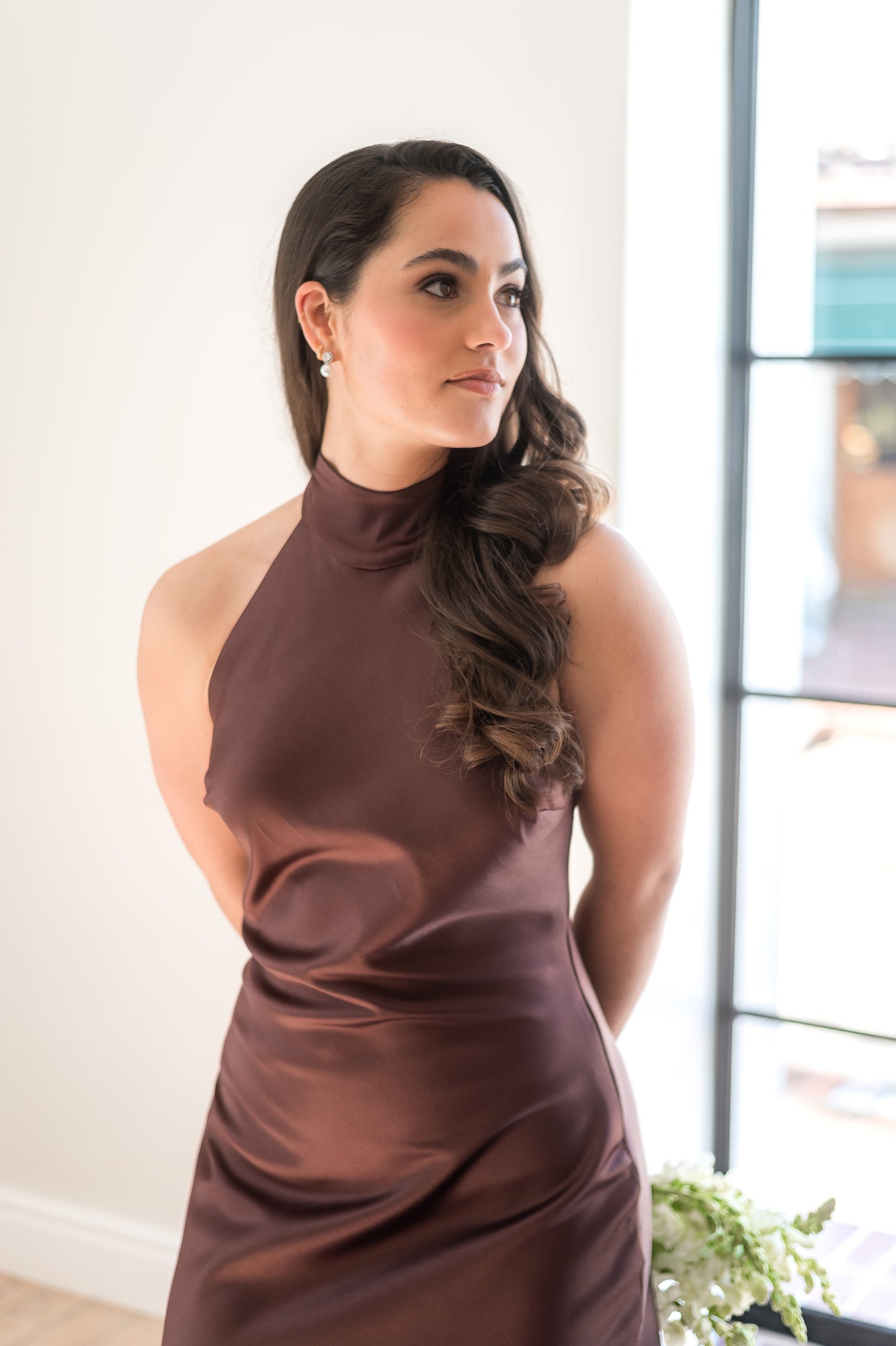 Woman wearing a coffee brown halter neck bridesmaids dress.